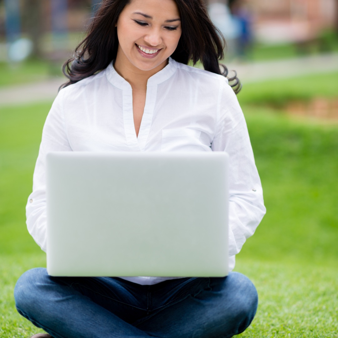 Woman using a laptop outdoors for business and general online notarization